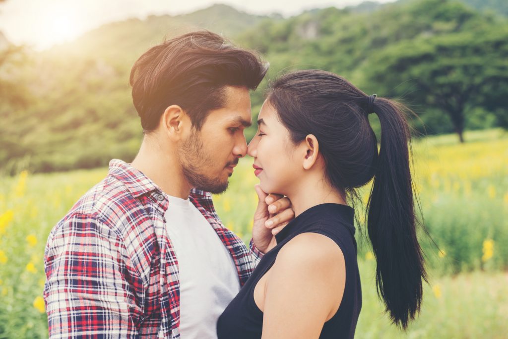 Young couple in love outdoor,Stunning sensual outdoor portrait of young hipster fashion couple posing in summer in field.