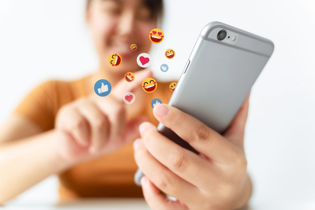 Young Asian woman using smartphone typing, chatting conversation